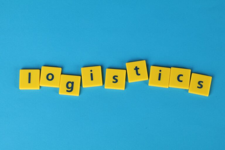 Yellow letter tiles spelling 'logistics' on a vibrant blue background, ideal for business and logistics themes.