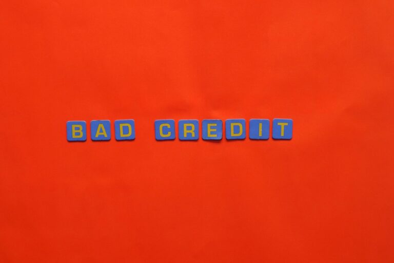 Blue letter blocks spelling 'Bad Credit' on an orange background.