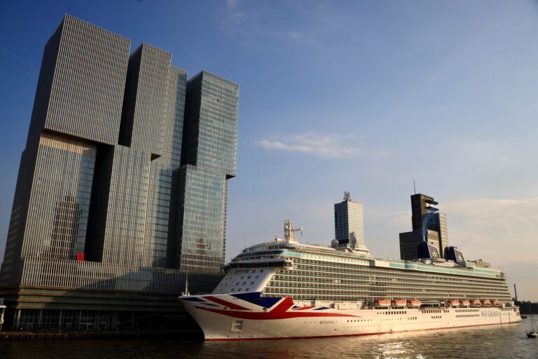 De Rotterdam towers and a cruise ship docked in Rotterdam, Netherlands.