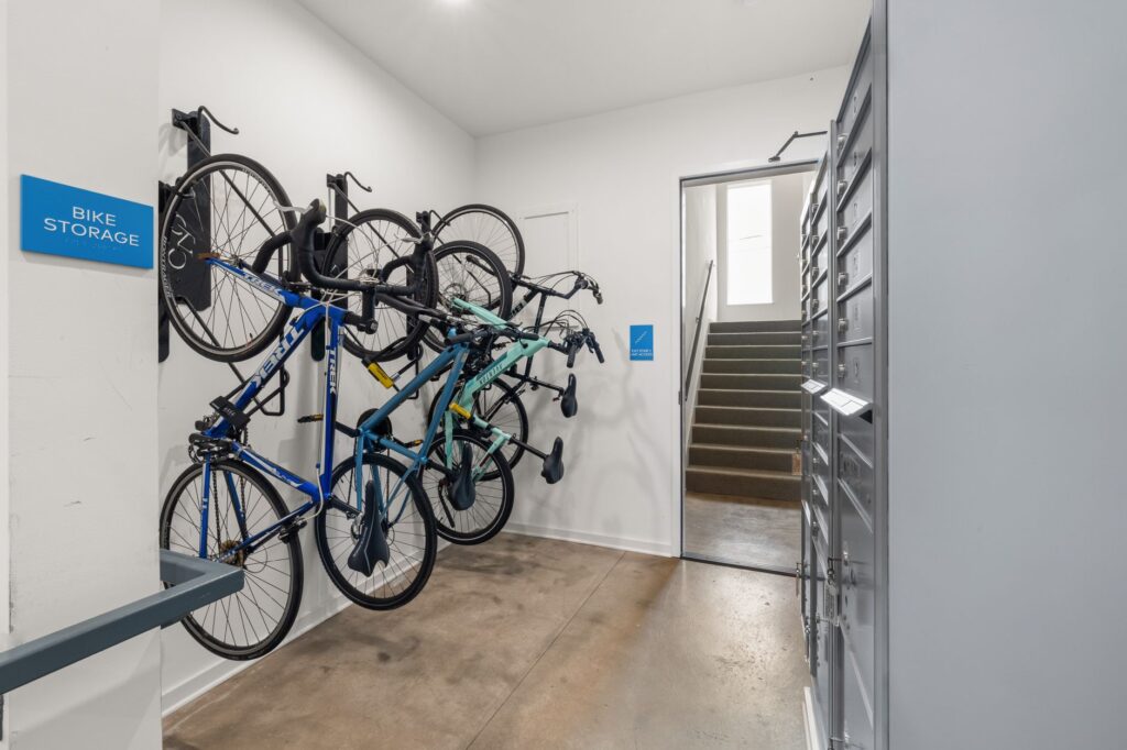 Modern indoor bike storage area with multiple bikes securely mounted on wall racks.