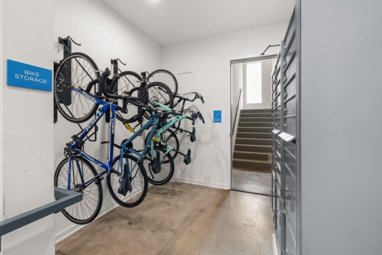 Modern indoor bike storage area with multiple bikes securely mounted on wall racks.