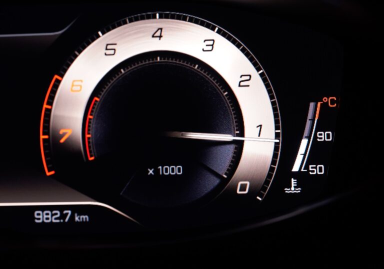 Close-up view of a car's RPM gauge on the dashboard with clear readings.