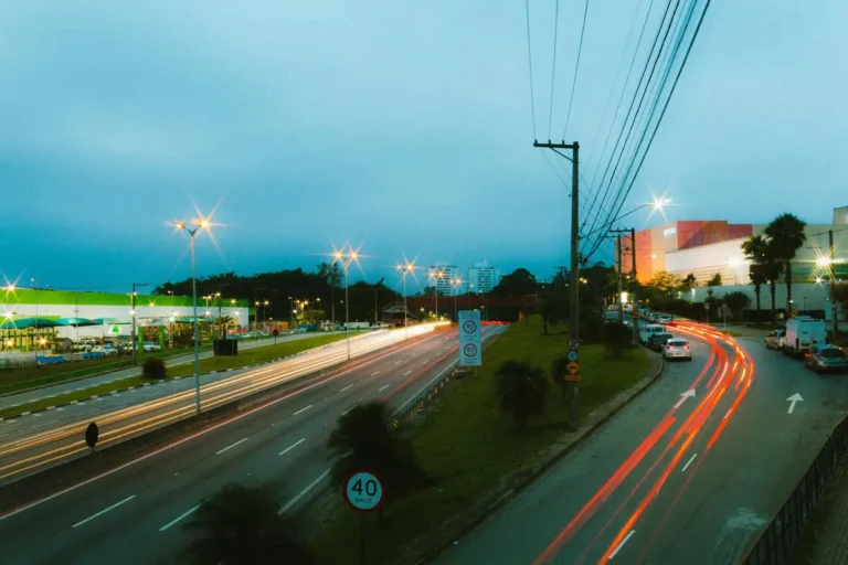 Dynamic long exposure shot of city highway at night with light trails.