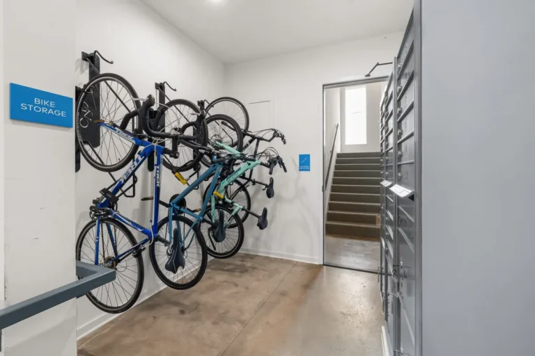 Modern indoor bike storage area with multiple bikes securely mounted on wall racks.