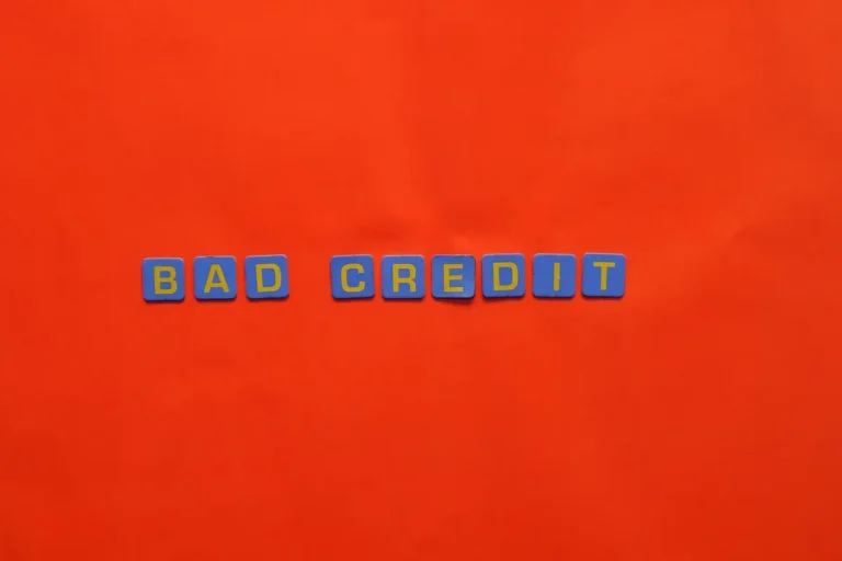 Blue letter blocks spelling 'Bad Credit' on an orange background.
