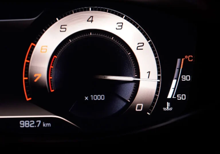 Close-up view of a car's RPM gauge on the dashboard with clear readings.