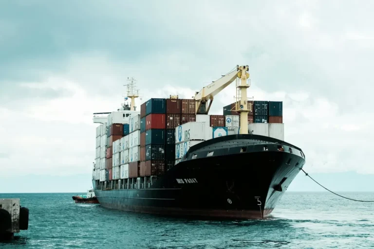 A large cargo ship loaded with shipping containers docked at Davao harbor, Philippines.